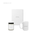 A candle, a journal and a mug, together