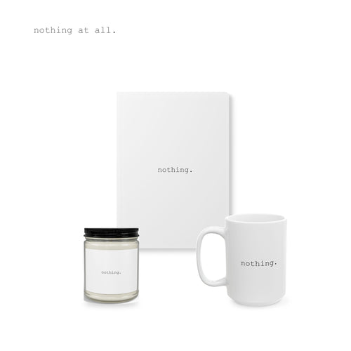 A candle, a journal and a mug, together